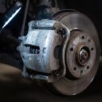 点検のためにライトで照らされた車のブレーキ部分のアップ